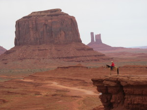 Navajo man posing with his horse.